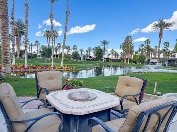a view of a chair and table in the garden