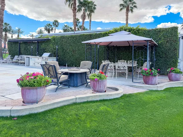 a view of a chair and table under an umbrella