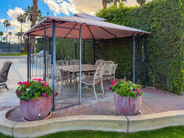 a view of a chair and table in patio with a potted plant
