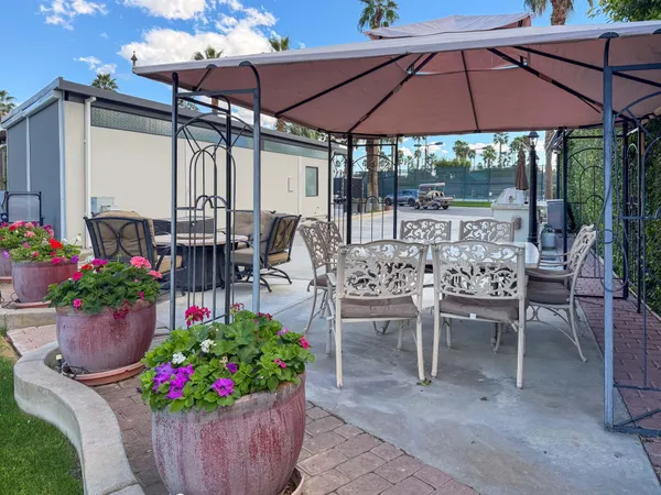 a view of a chairs and table under an umbrella