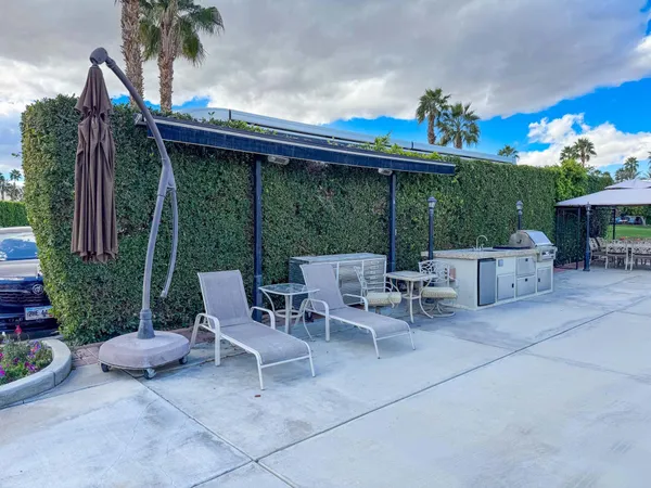 a view of a patio with a table and chairs