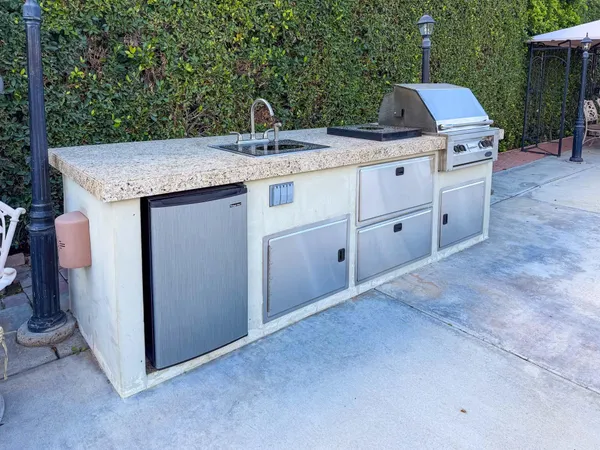 a view of kitchen with sink and microwave