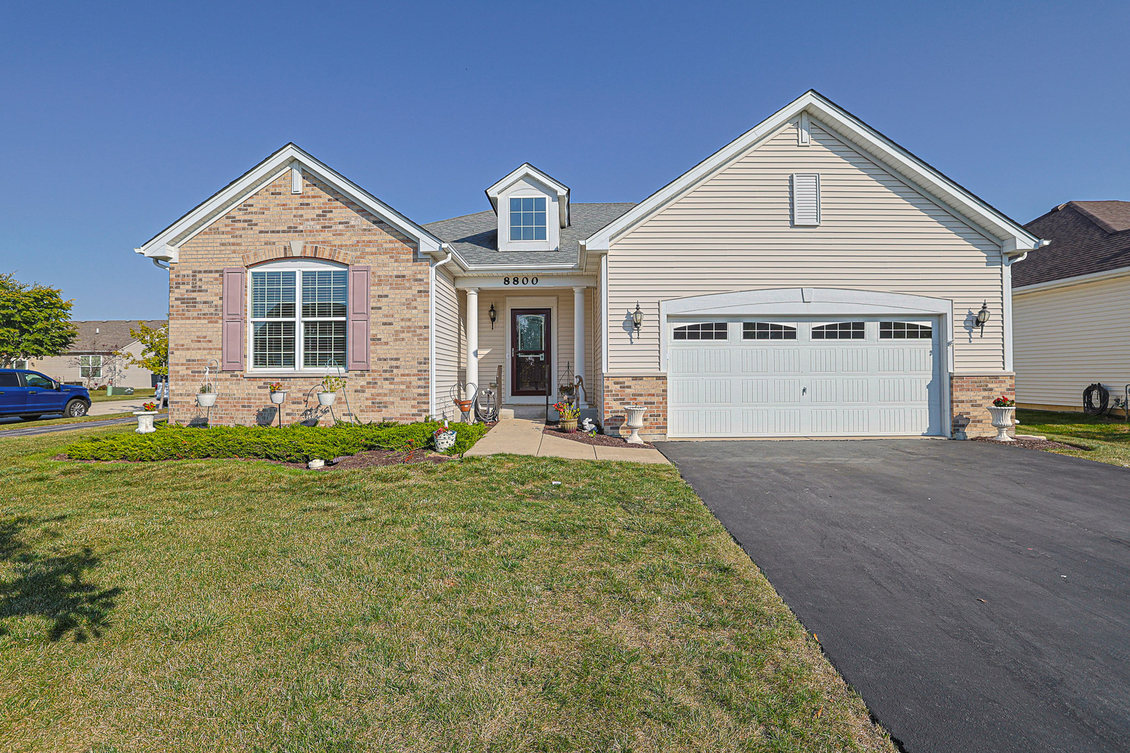 8800 Templeton Road Huntley, IL 60142 - Photo 1 of 31 a front view of a house with a yard and garage