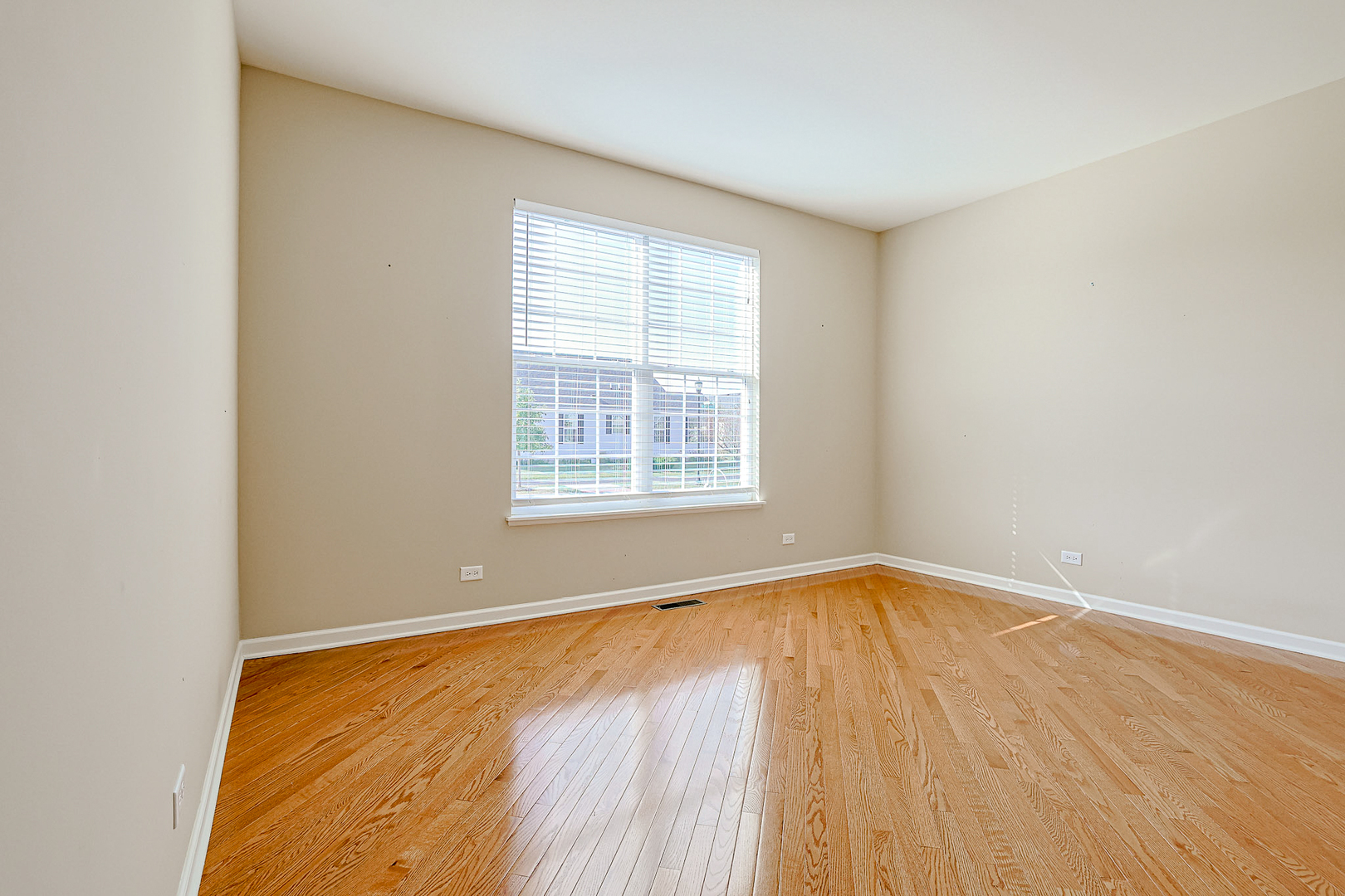 8800 Templeton Road Huntley, IL 60142 - Photo 14 of 31 a view of an empty room with wooden floor and a window