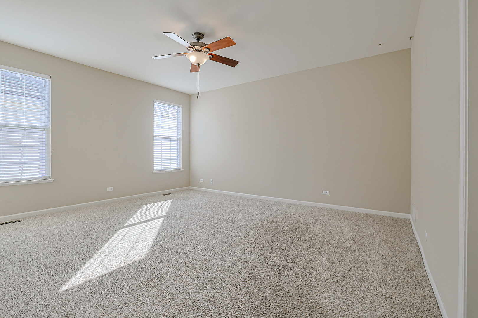 8800 Templeton Road Huntley, IL 60142 - Photo 19 of 31 an empty room with windows and fan