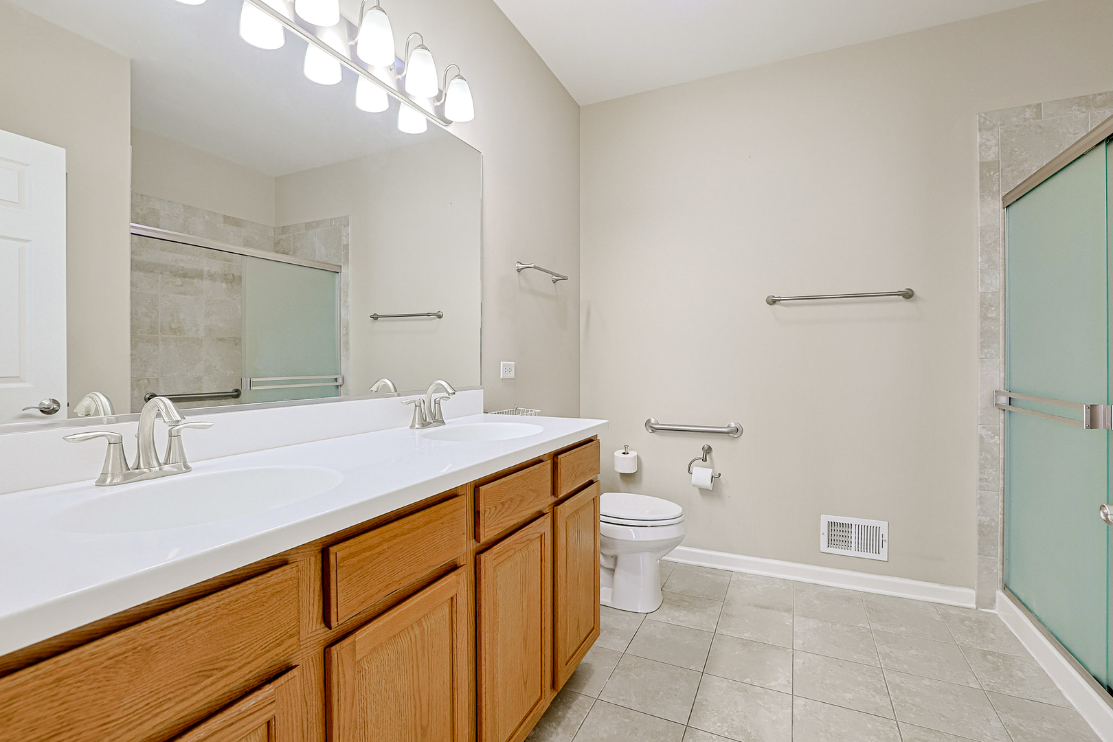 8800 Templeton Road Huntley, IL 60142 - Photo 20 of 31 a bathroom with a sink a toilet and a mirror