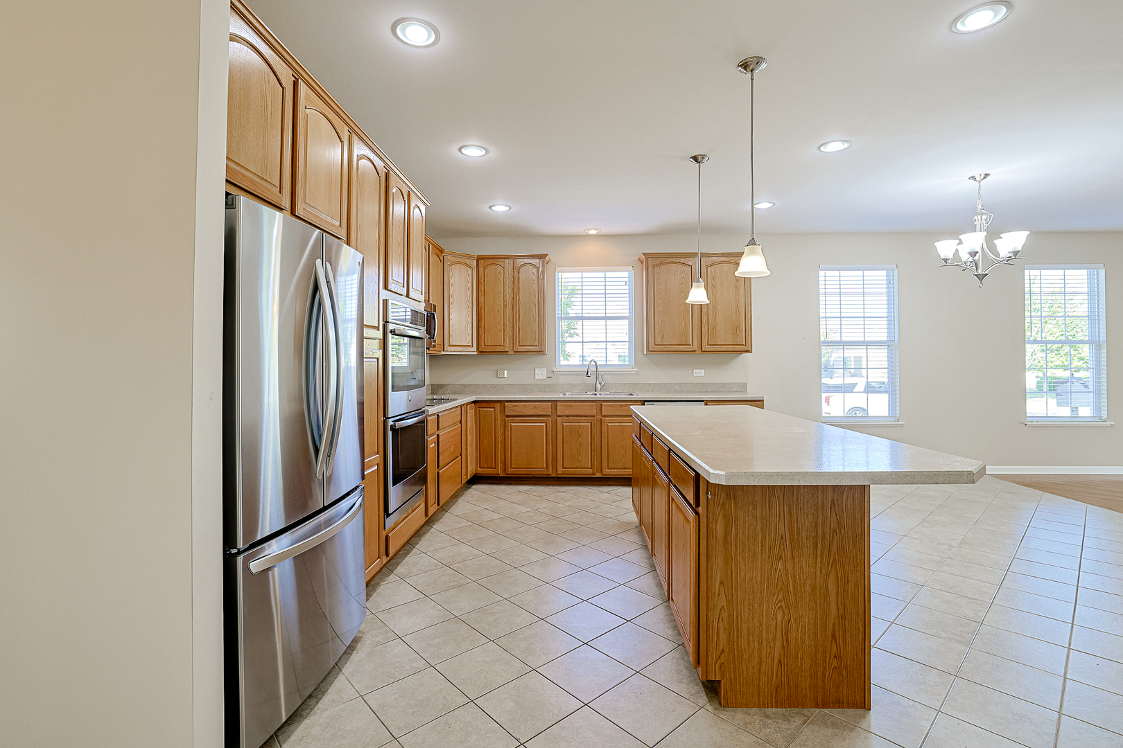 8800 Templeton Road Huntley, IL 60142 - Photo 5 of 31 a kitchen with stainless steel appliances granite countertop a refrigerator a sink and a stove