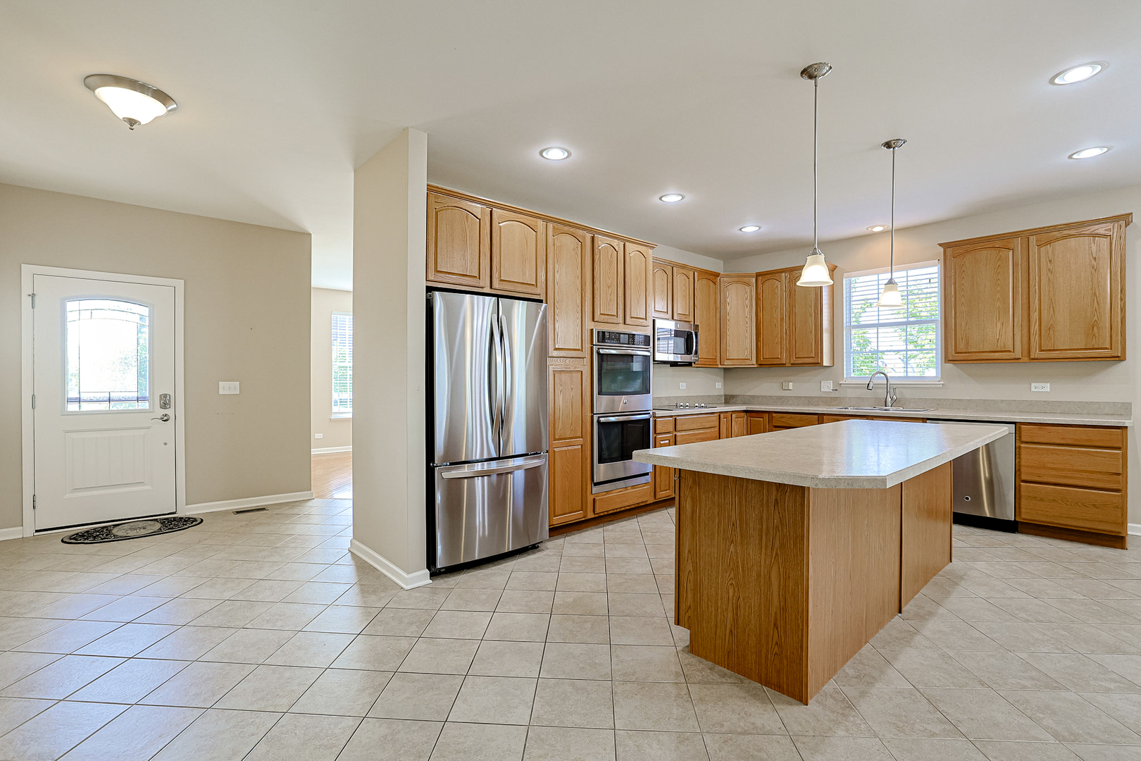 8800 Templeton Road Huntley, IL 60142 - Photo 6 of 31 a kitchen with stainless steel appliances granite countertop a refrigerator a sink a stove a microwave and island