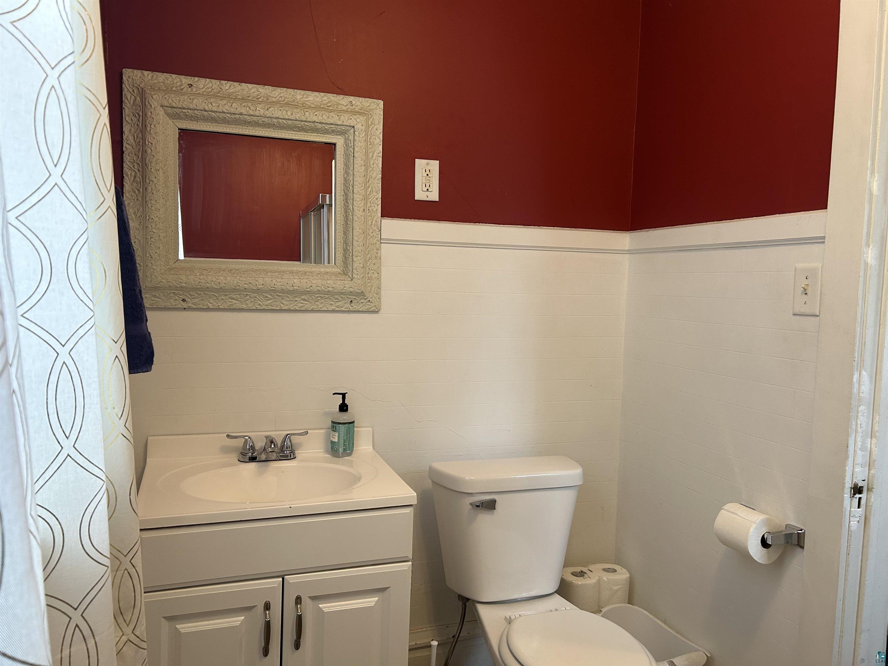 1723 East 4th Street Duluth, MN 55812 - Photo 13 of 47 Half bathroom featuring vanity and tile walls