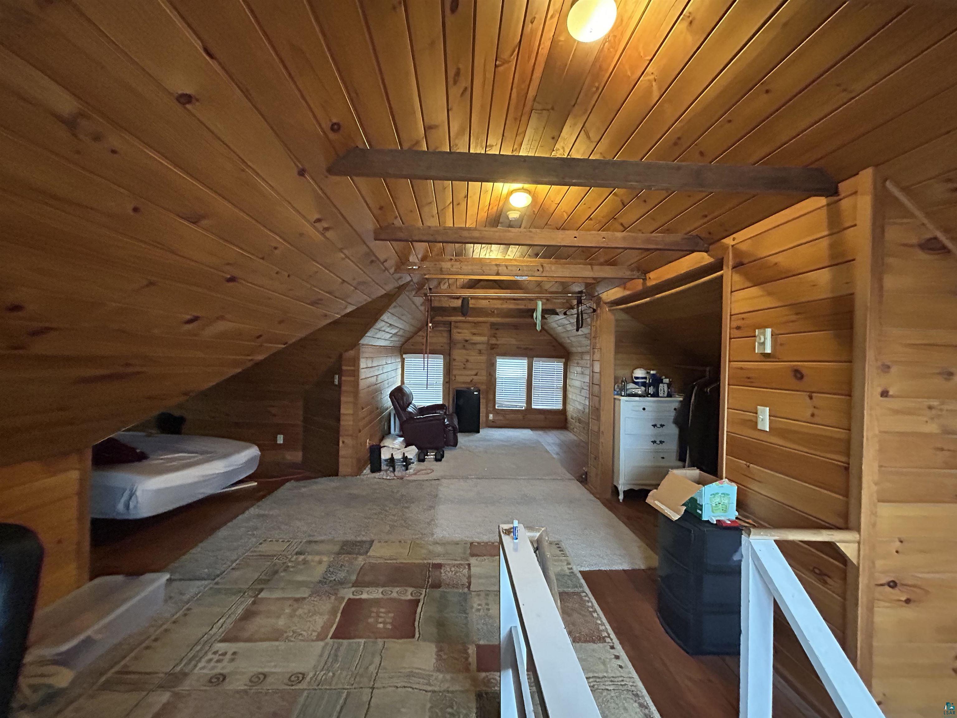 1723 East 4th Street Duluth, MN 55812 - Photo 22 of 47 Additional living space with wooden walls, wood ceiling, and vaulted ceiling with beams