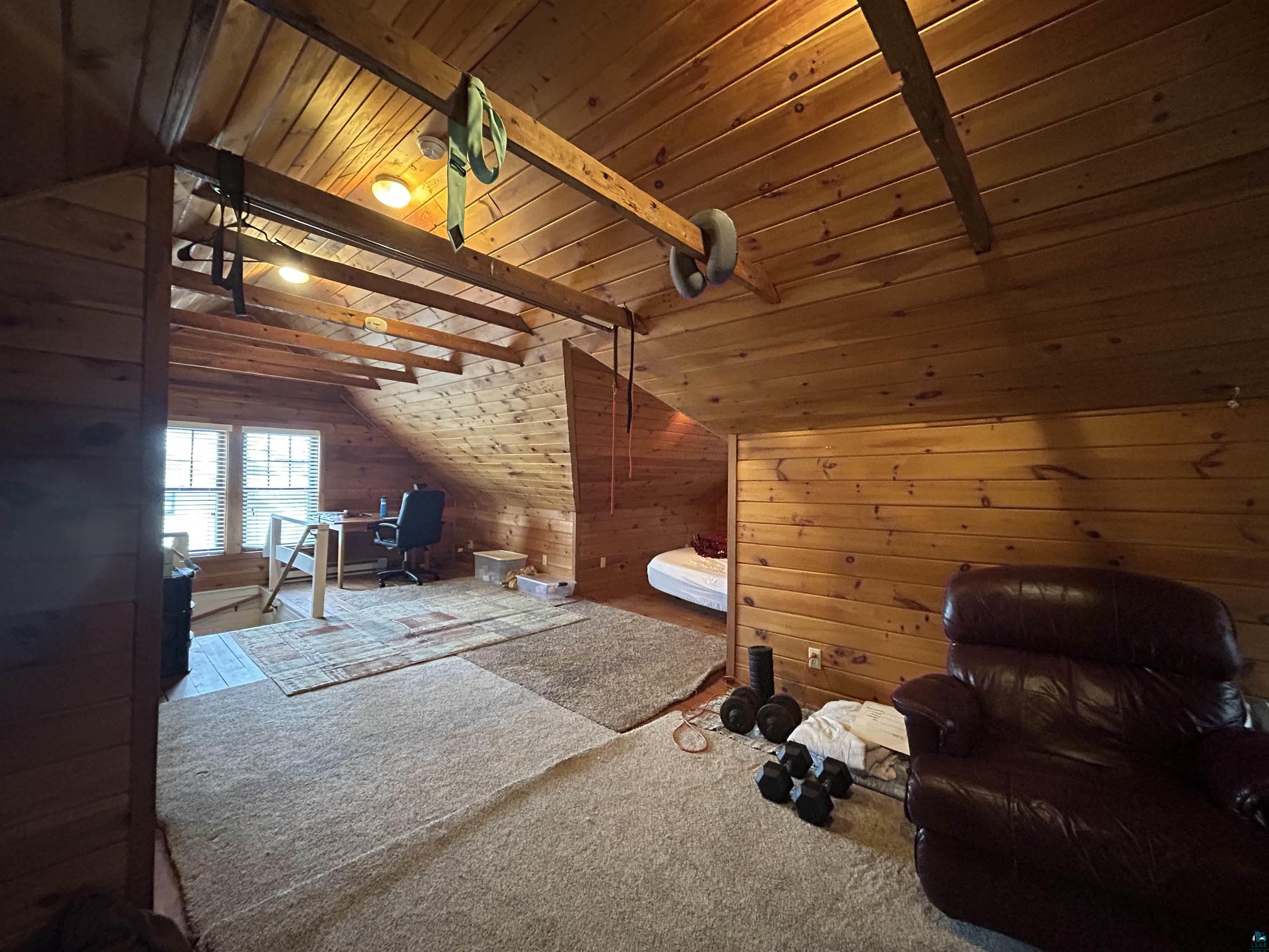 1723 East 4th Street Duluth, MN 55812 - Photo 23 of 47 Additional living space with wooden walls, a desk, wooden ceiling, lofted ceiling with beams, and carpet flooring