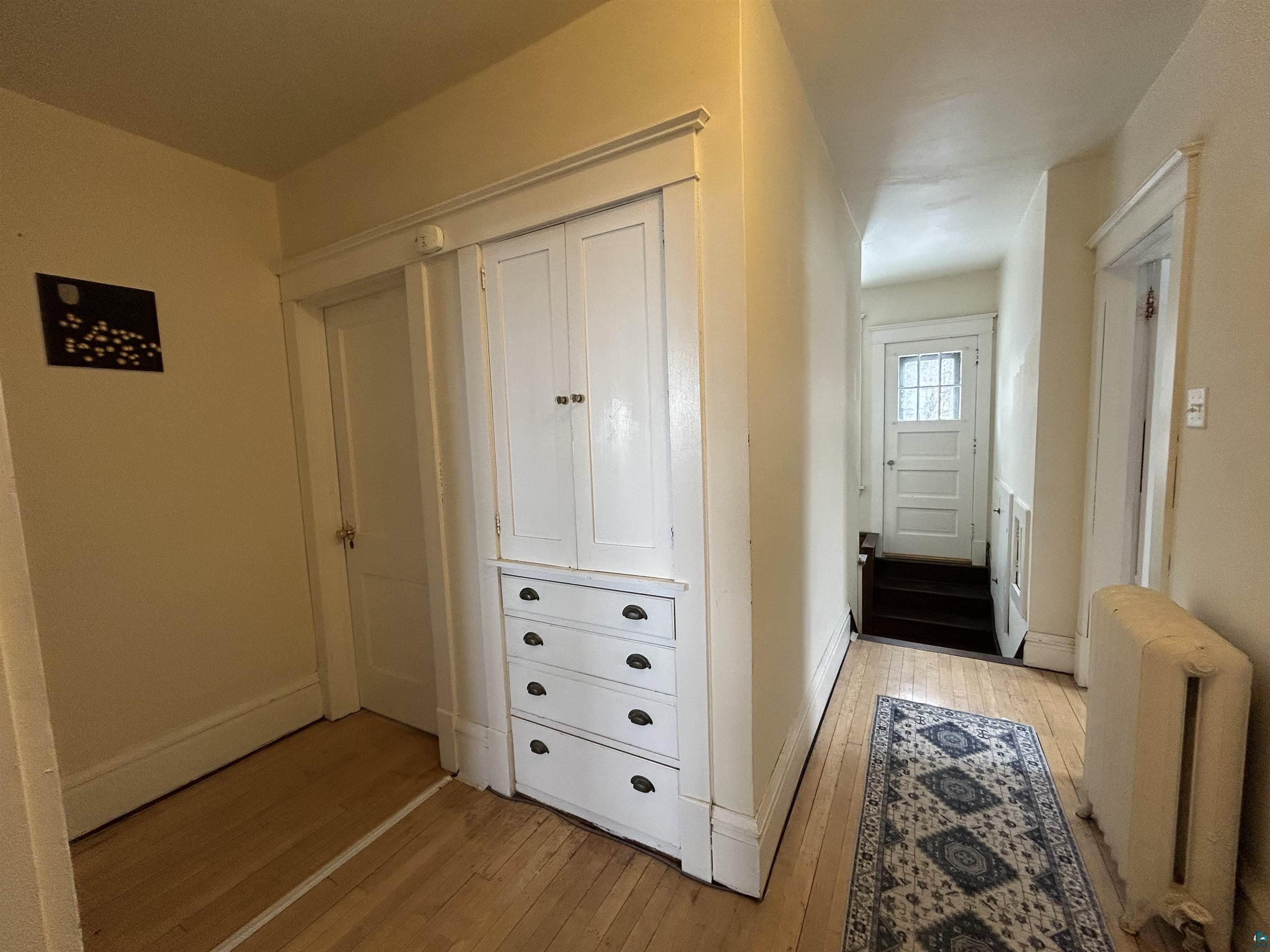 1723 East 4th Street Duluth, MN 55812 - Photo 24 of 47 Doorway to outside featuring radiator heating unit and hardwood / wood-style flooring