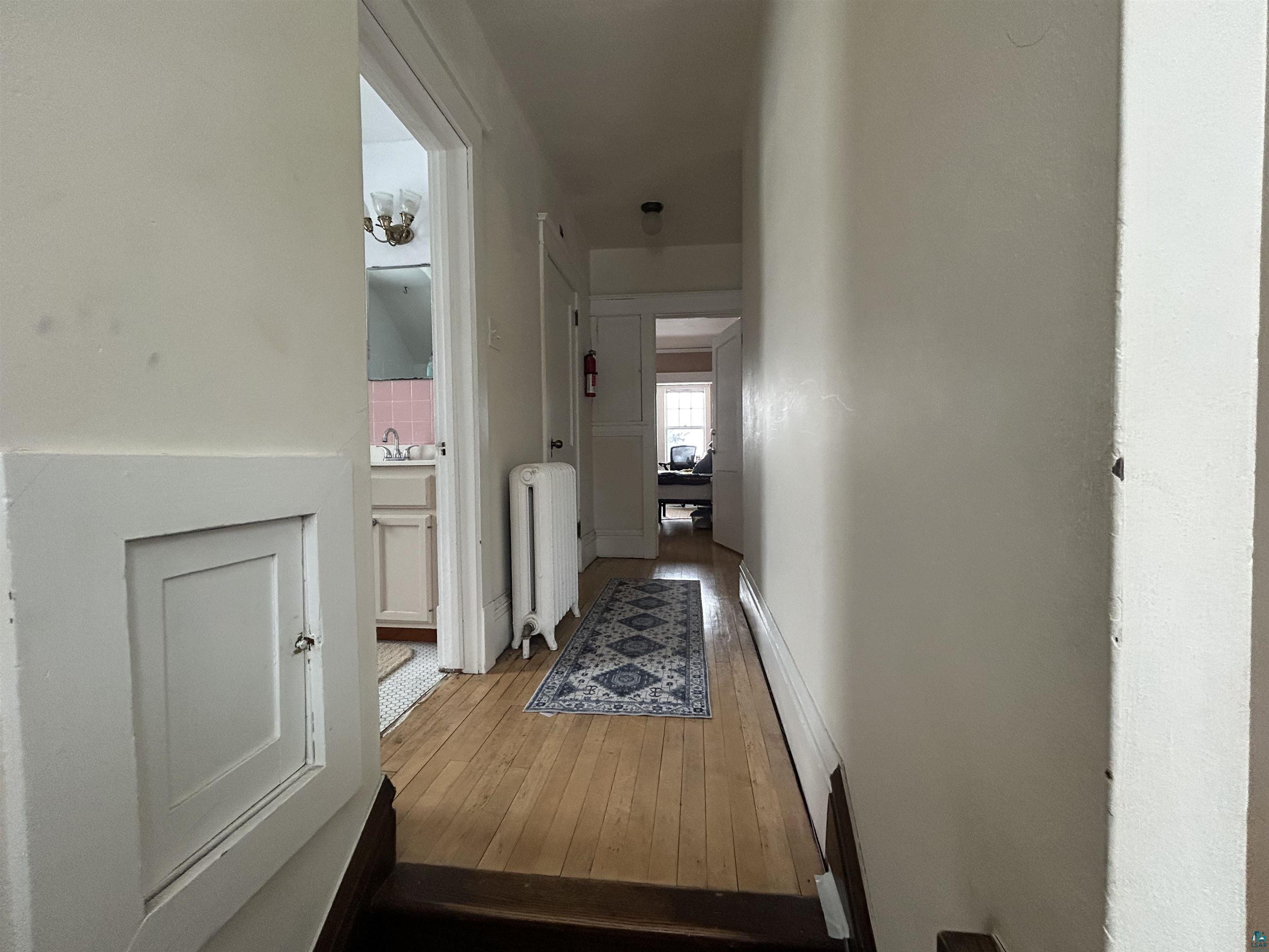 1723 East 4th Street Duluth, MN 55812 - Photo 29 of 47 Corridor featuring radiator and light wood-type flooring