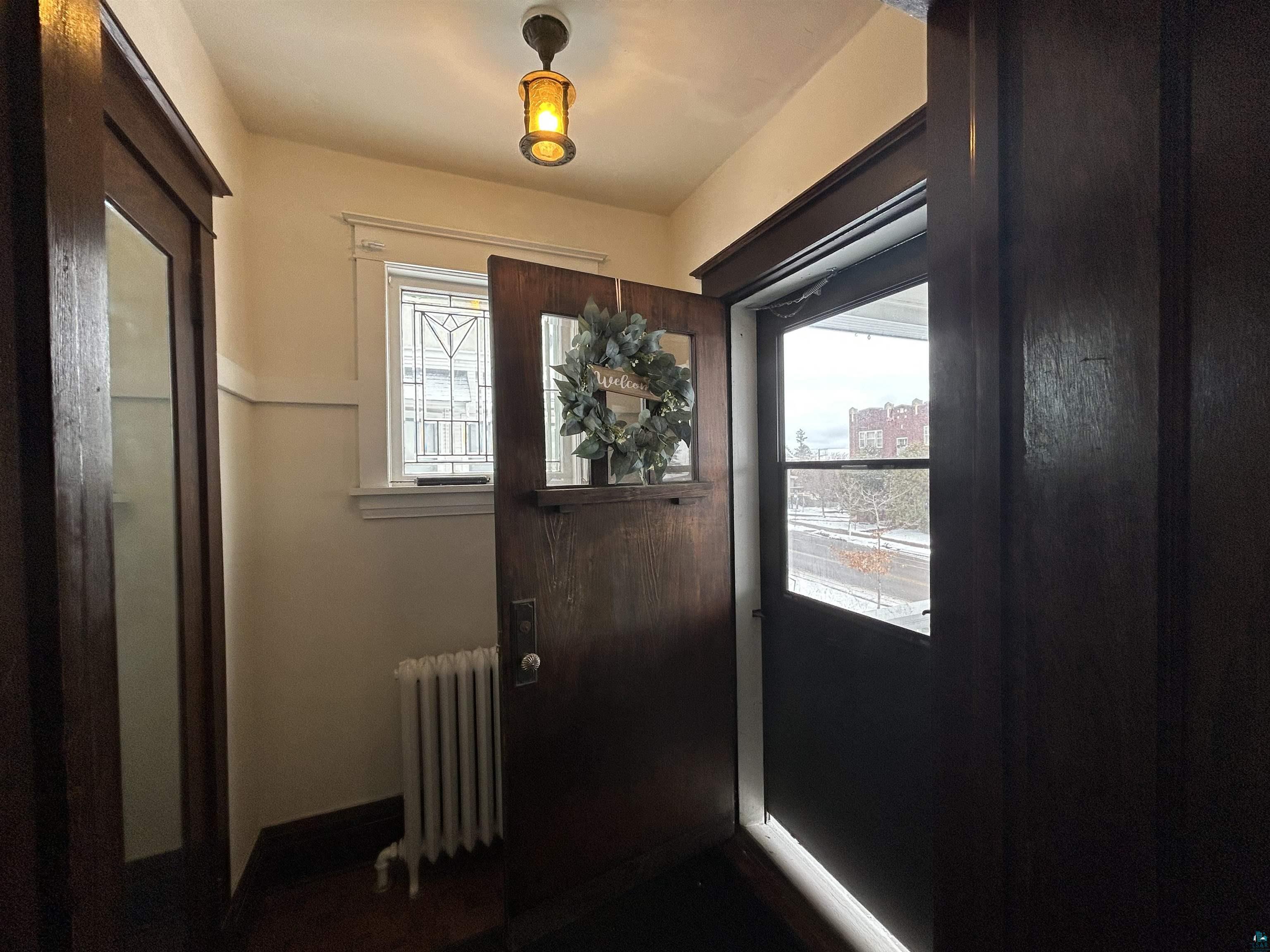 1723 East 4th Street Duluth, MN 55812 - Photo 30 of 47 Doorway with radiator and baseboards