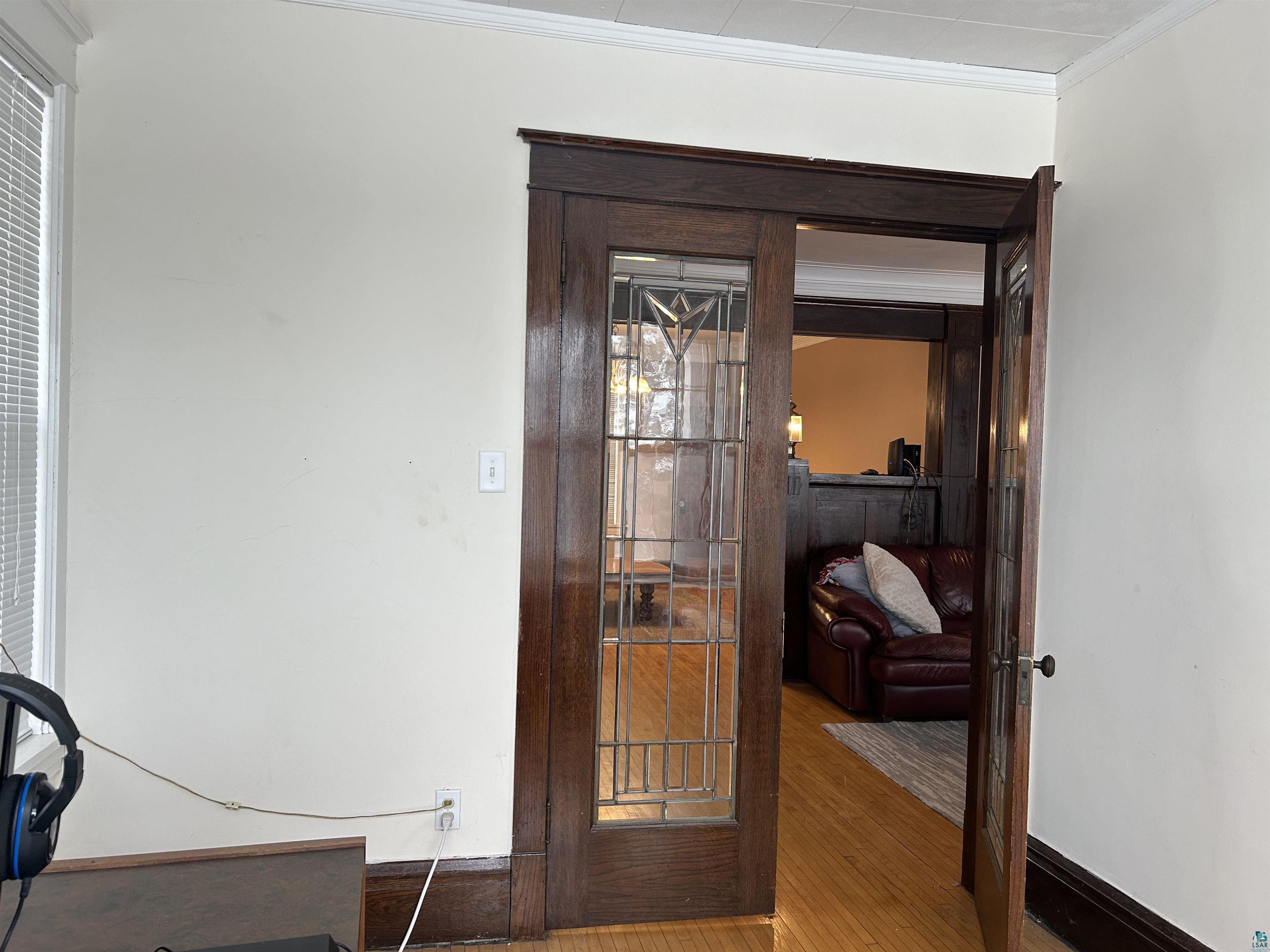 1723 East 4th Street Duluth, MN 55812 - Photo 36 of 47 Detailed view of wood finished floors, crown molding, and french doors