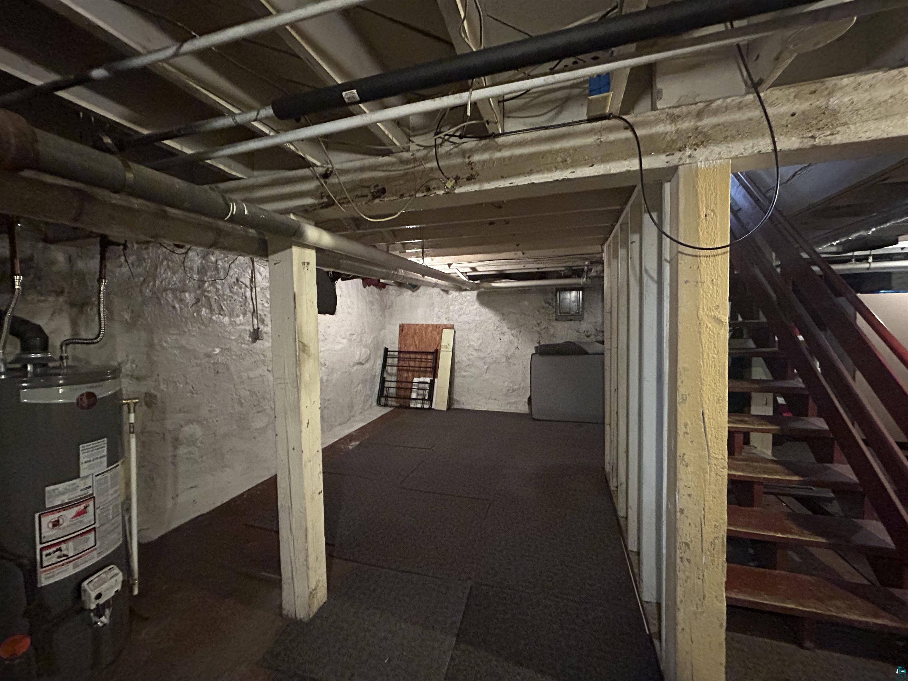 1723 East 4th Street Duluth, MN 55812 - Photo 39 of 47 Unfinished basement with stairs and gas water heater