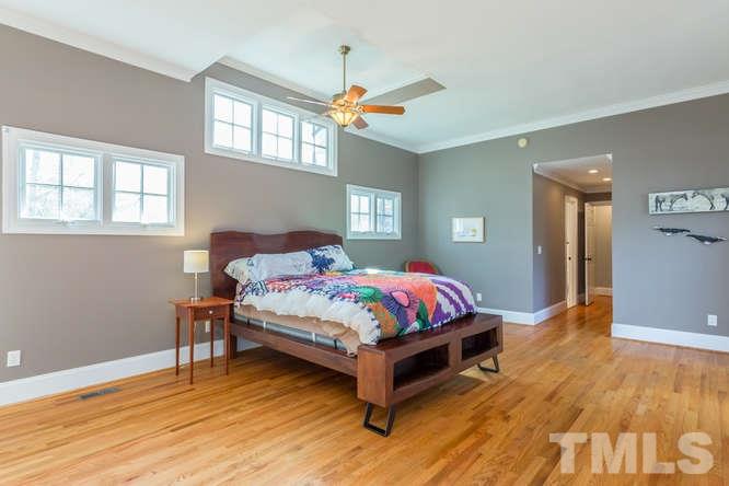 906 Runnymede Road Raleigh, NC 27607 - Photo 14 of 25 a bedroom with a bed and a table