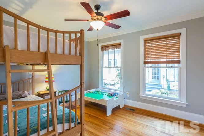906 Runnymede Road Raleigh, NC 27607 - Photo 23 of 25 a bedroom with furniture window and wooden floor