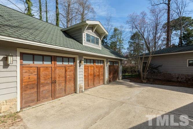 906 Runnymede Road Raleigh, NC 27607 - Photo 4 of 25 a view of a house with large windows and a outdoor space