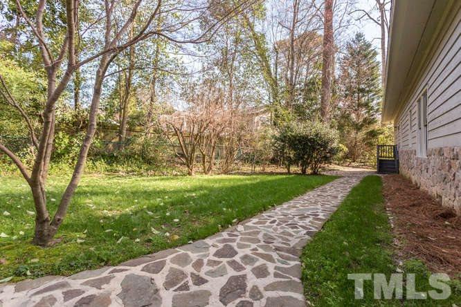 906 Runnymede Road Raleigh, NC 27607 - Photo 5 of 25 a view of a yard with plants and trees