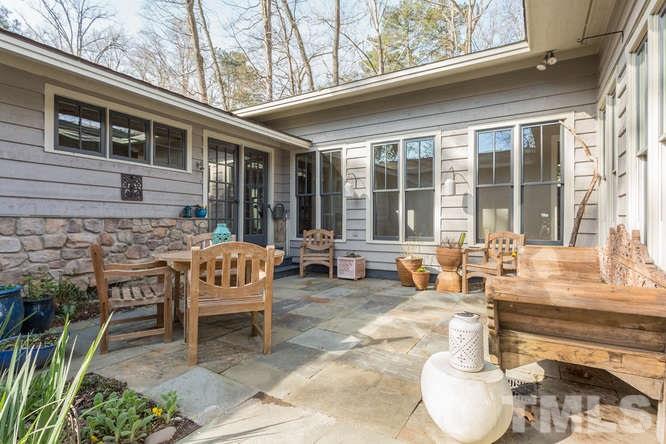 906 Runnymede Road Raleigh, NC 27607 - Photo 7 of 25 a backyard of a house with outdoor seating