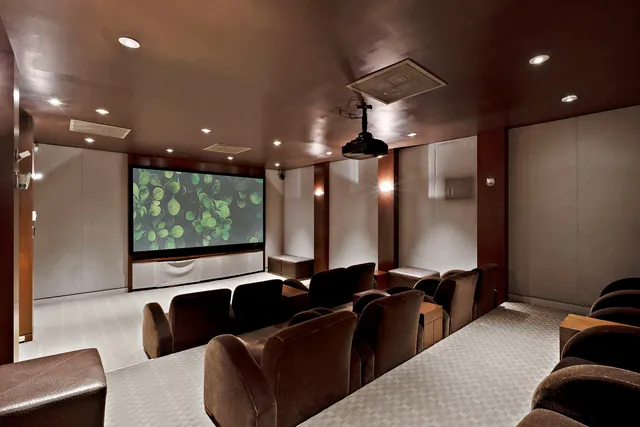 a living room with furniture and a projector screen