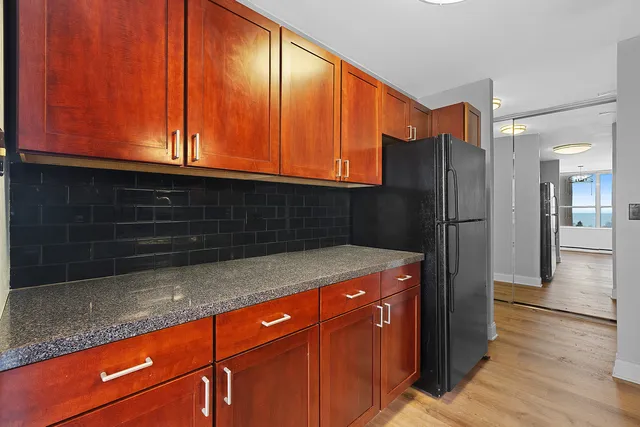 a kitchen with stainless steel appliances granite countertop a refrigerator and a sink