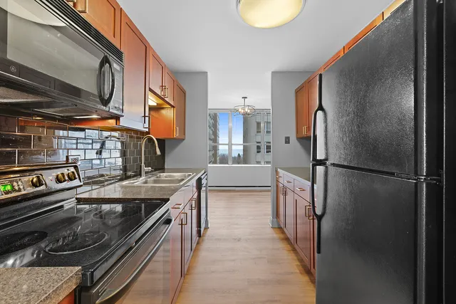 a kitchen with a refrigerator and a sink