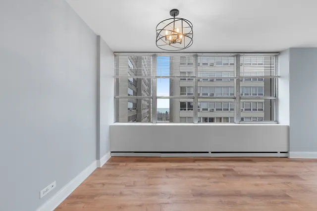 a view of wooden floor and windows in a room
