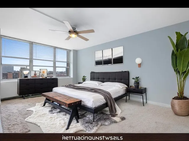 a bed room with a bed and a potted plant