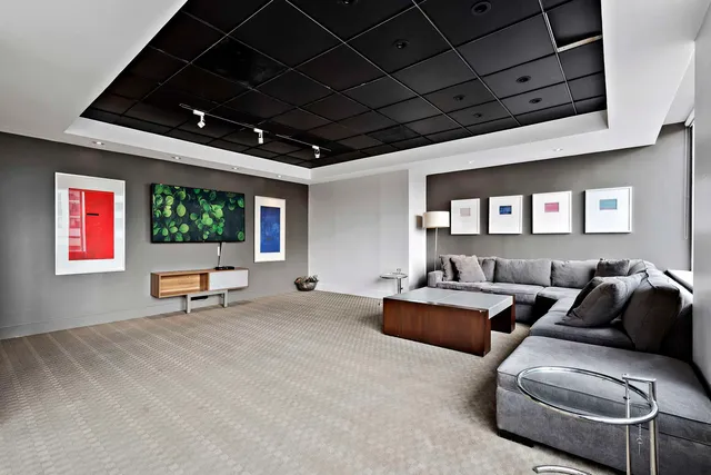 a living room with furniture a window and a flat screen tv