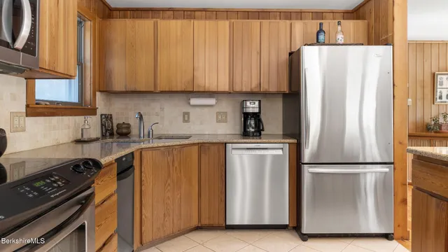 a kitchen with stainless steel appliances a refrigerator and a sink