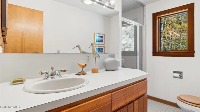 a spacious bedroom with a bed and cabinet