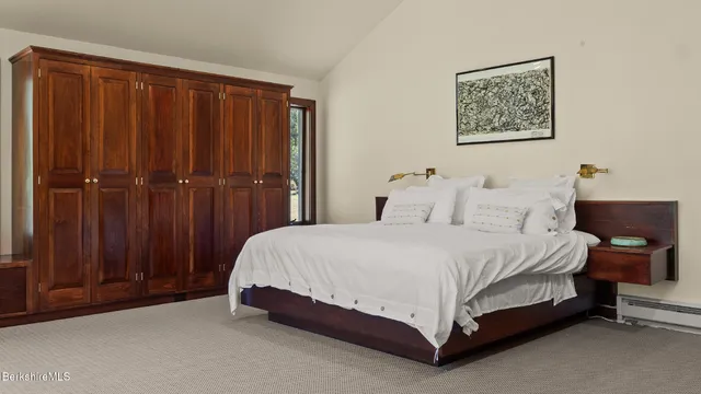 a bedroom with a large bed and a large window