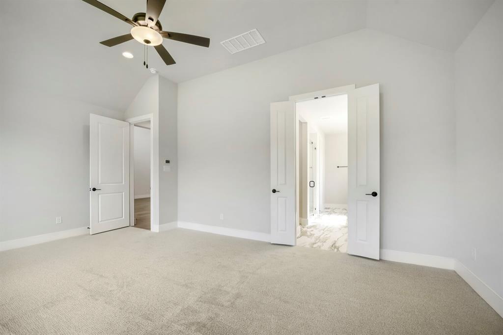 800 Blackberry Road Haslet, TX 76052 - Photo 14 of 28 Spacious room featuring vaulted ceilings, light-toned carpeting, and a ceiling fan with integrated lighting