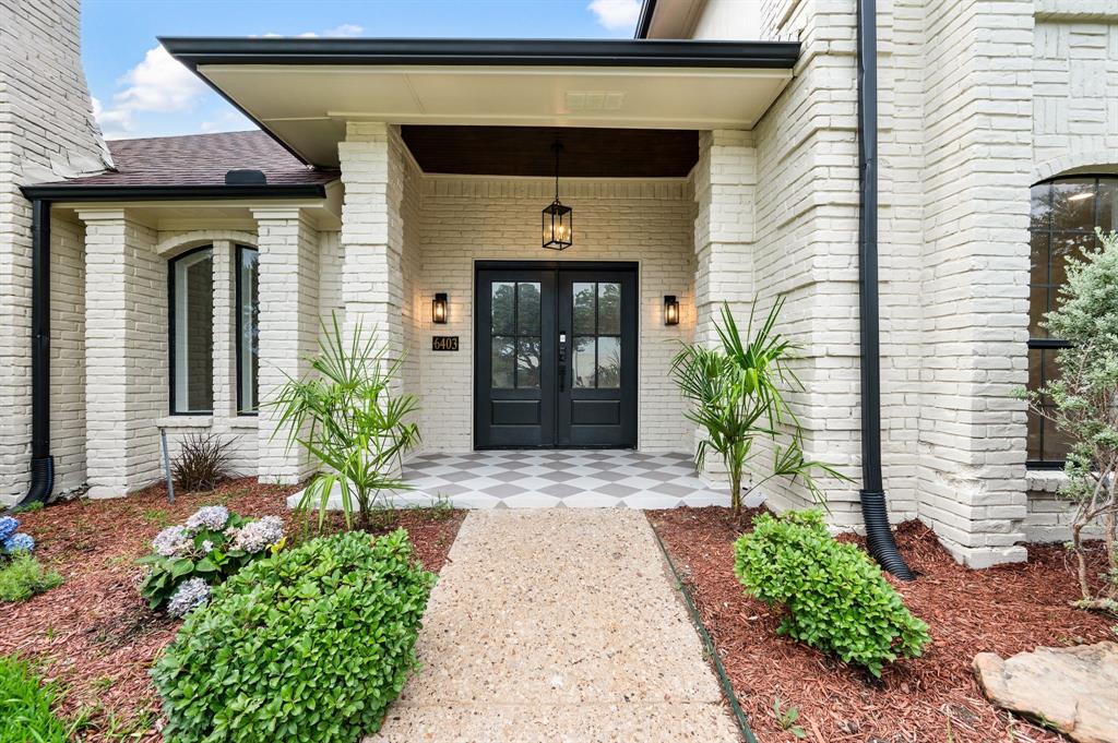6403 Genstar Lane Dallas, TX 75252 - Photo 2 of 34 White-painted brick exterior featuring a covered entry, double black doors with glass panels, and a checkered tile porch