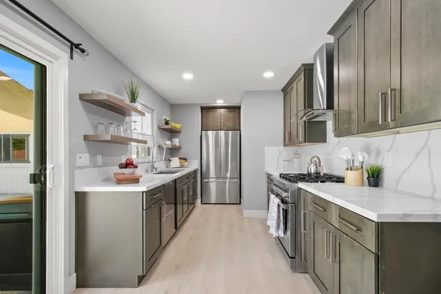 a close view of a refrigerator in kitchen and a sink