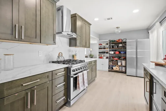 a spacious bedroom with a bed a couch and potted plant