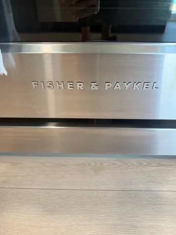 a spacious bedroom with a bed a dresser and a large window