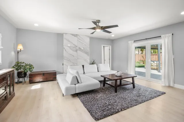 a bathroom with a granite countertop sink a toilet a mirror and shower