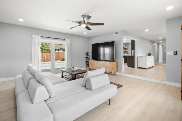 a view of a workspace with furniture and window