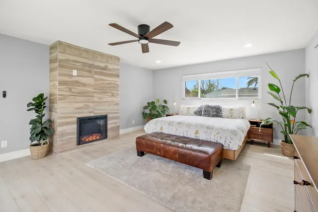 a bedroom with a large bed and a chandelier