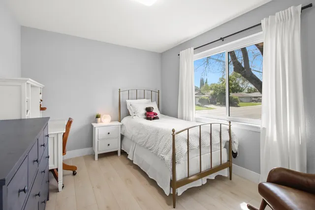 a front view of a house with a garden and yard