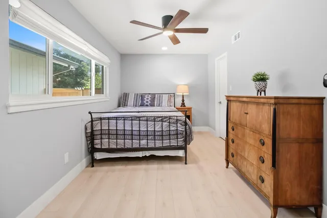 a view of a house with backyard and a tree