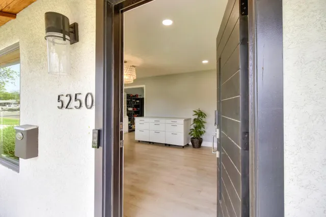 a living room with furniture a dining table and kitchen view