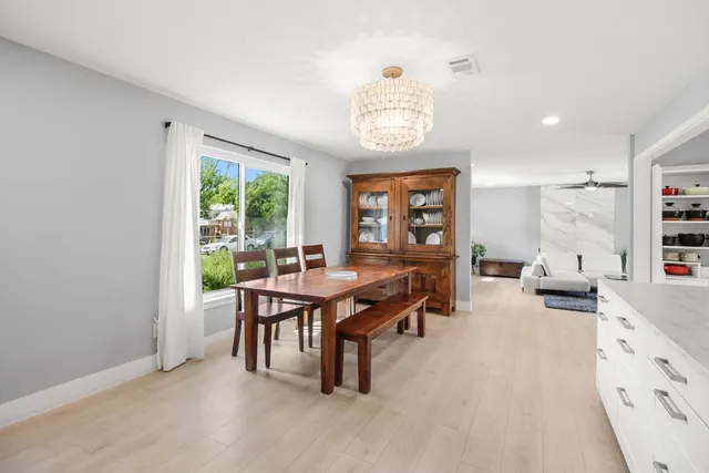 a kitchen with kitchen island a sink stainless steel appliances and cabinets