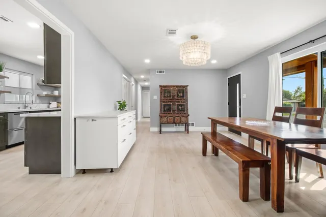 a kitchen with stainless steel appliances a sink stove refrigerator and cabinets
