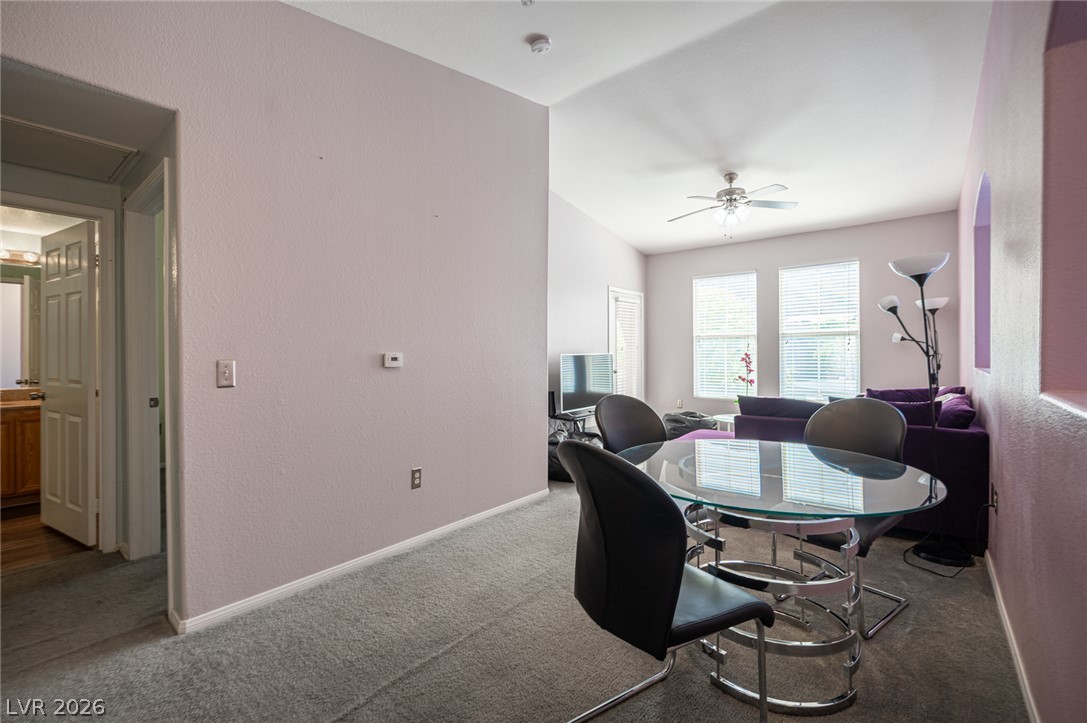 10550 West Alexander Road, Unit 2014 Las Vegas, NV 89129 - Photo 9 of 43 Sunlight streams through large windows into this inviting space with carpeted flooring and vaulted ceilings.