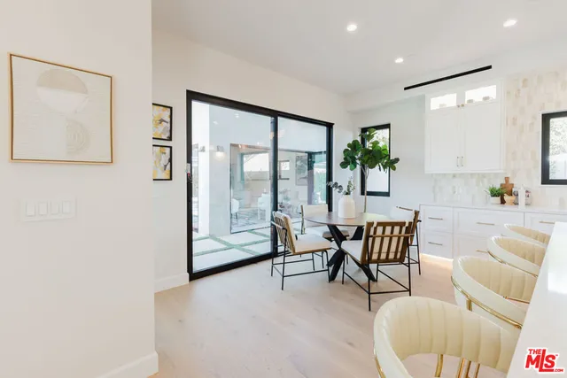 a dining room with furniture and wooden floor