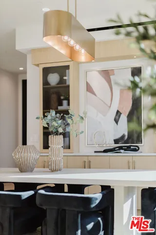 a view of hall with a table and chairs